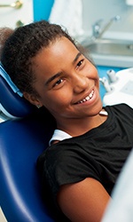 Preteen girl smiling in dental chair