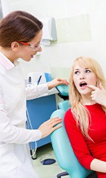Patient pointing out her problem tooth to her dentist