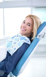 Side view of smiling dental patient in treatment chair