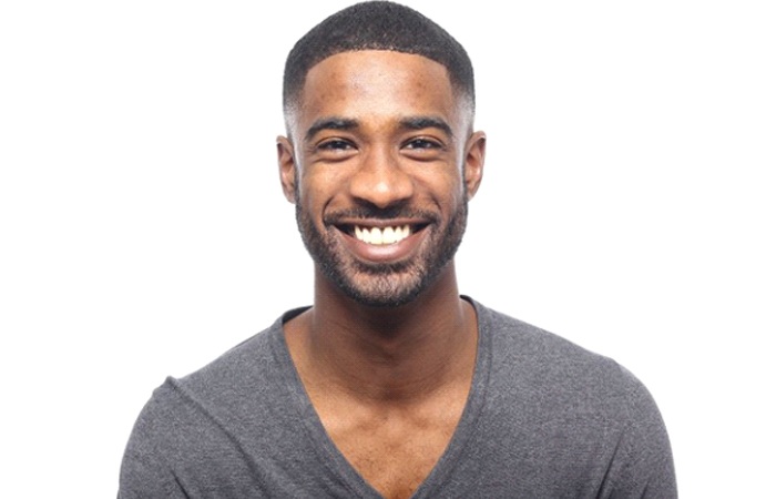 man in black shirt smiling after getting cosmetic teeth bonding in Studio City