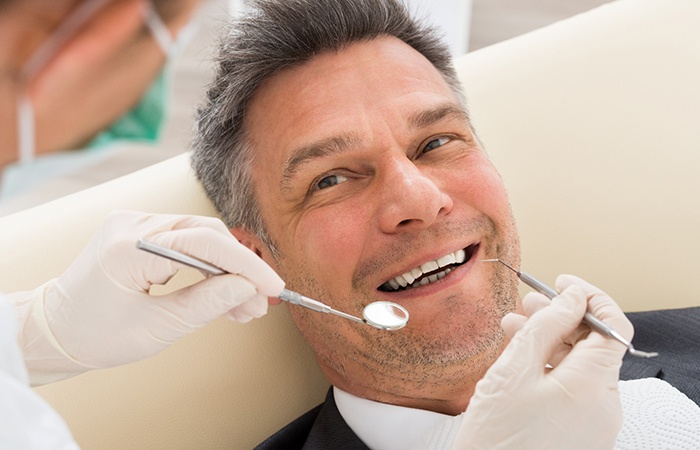 Man smiling at the dentist