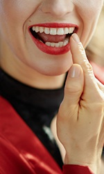 Woman pointing to her tooth