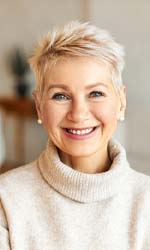woman smiling after understanding the cost of dentures in Studio City