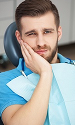 Man holding jaw in pain