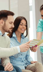 Dentist showing financial paperwork to patients