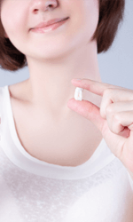 Woman holding extracted tooth giving thumbs up