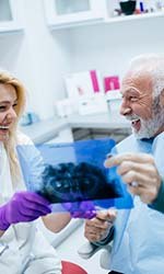 Smiling man admiring his new dental implants in Studio City