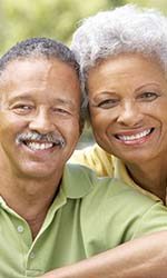 Couple with dental implants in Studio City smiling outside