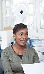 Woman learning about becoming a candidate for dental implants in Studio City