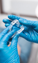 Dentist holding aligners
