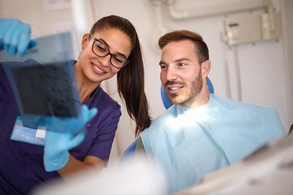 Man looking at dental x-ray