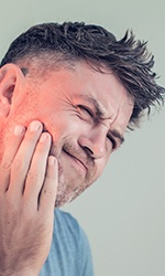 Portrait of man experiencing jaw pain