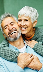 Smiling older couple with healthy teeth