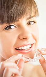 Woman placing Invisalign tray