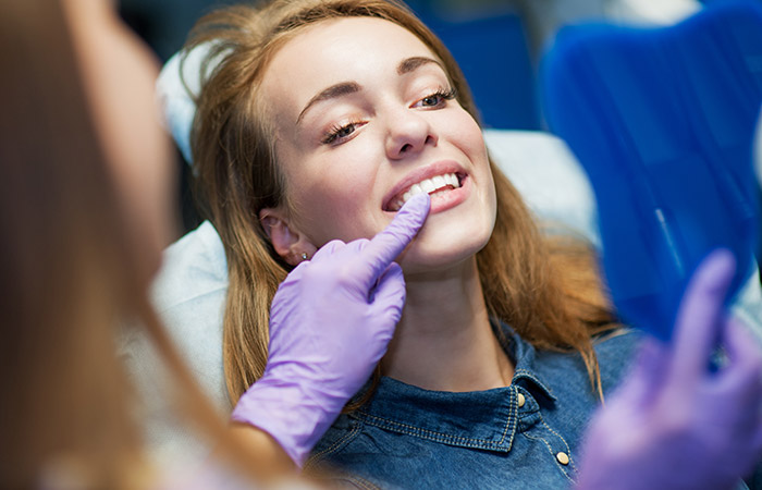 Woman looking at smile in mirror