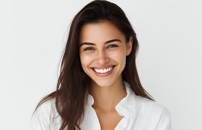 Portrait of confident young woman with beautiful teeth