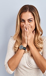 Woman shyly covering her mouth