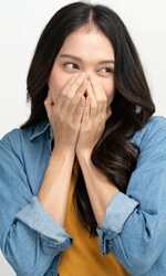 laughing woman covering her mouth