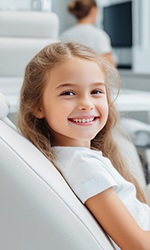 Little girl smiling in the dentist’s chair 
