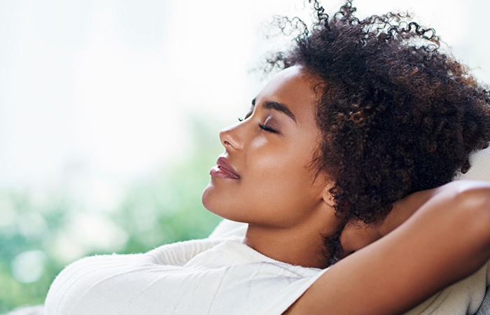 Relaxing woman with hands behind head