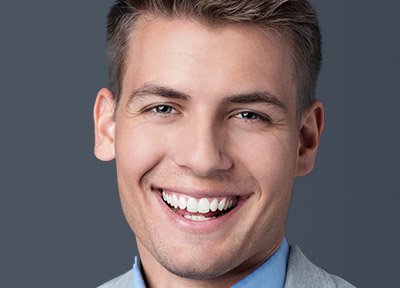 Smiling young man with glasses