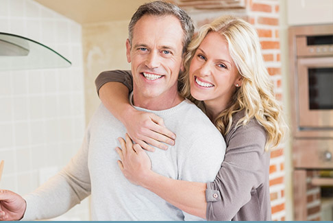 Man and woman smiling in kitchen