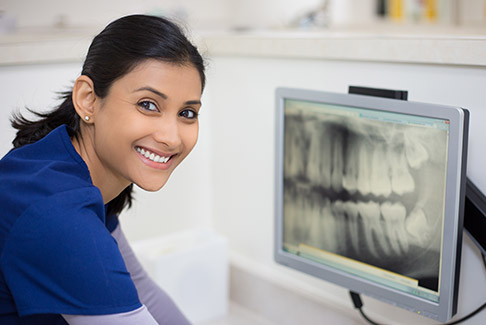 Dentist looking at digital x-rays