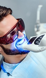 Man smiling during in-office teeth whitening in Studio City