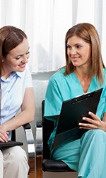 Patient and dentist looking at a clipboard