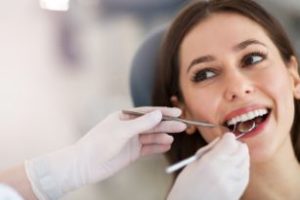 Woman getting an exam from a dentist