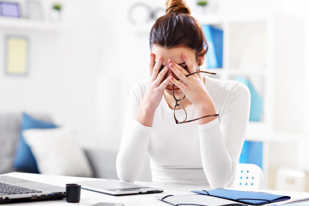 Woman looking sad in her home office