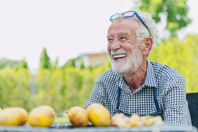 older man smiling while outdoors
