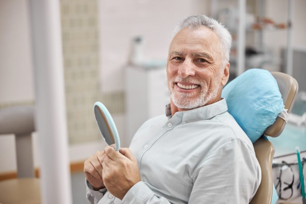 Man smiling while visiting dentist