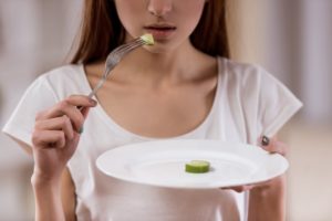 a woman barely eating any food