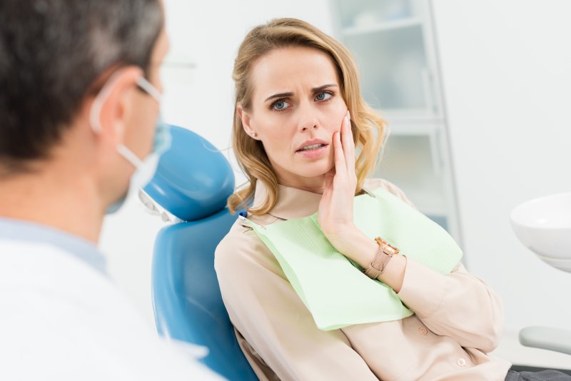 Patient talking to dentist about dental emergencies
