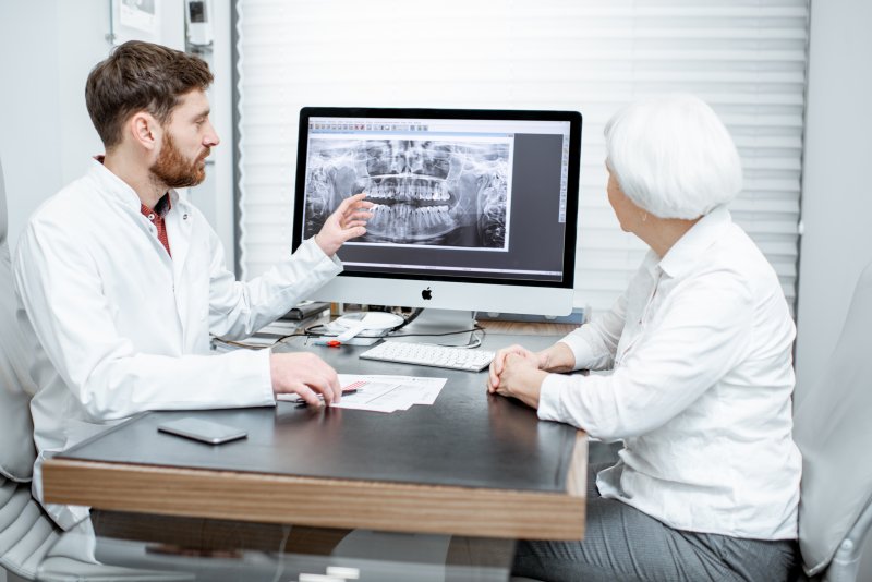 dentist discussing tooth extraction with patient